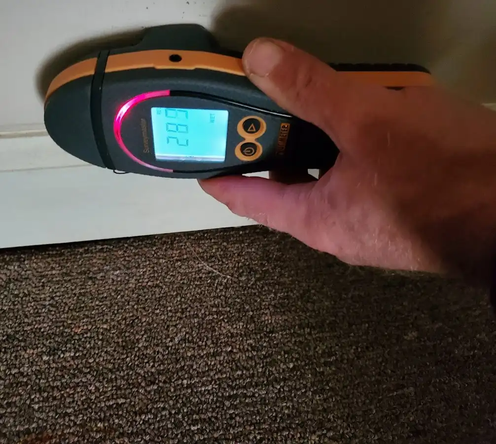 Moisture detection at baseboard during Storm Damage Restoration in North Fort Myers